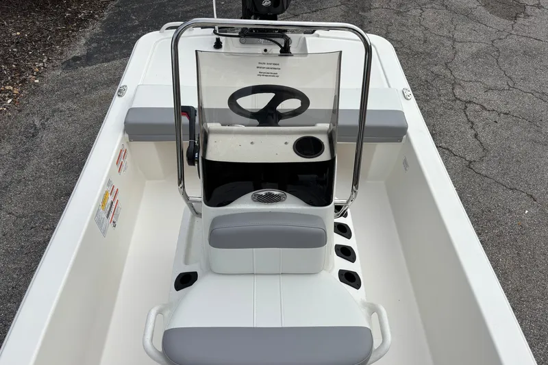 Slide: The Image of 2026 Mako Pro Skiff 13 CC boat interior with steering console and seating. - 13