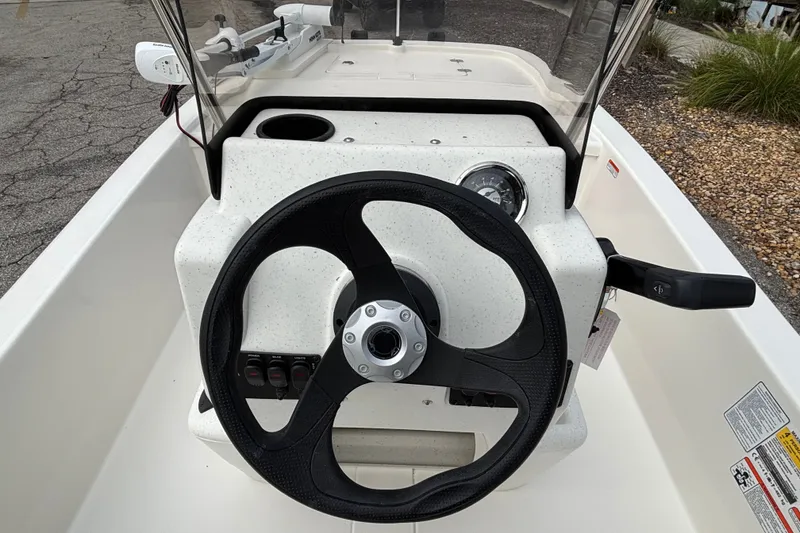 Slide: The Image of 2026 Mako Pro Skiff 13 CC boat console with steering wheel and controls. - 7