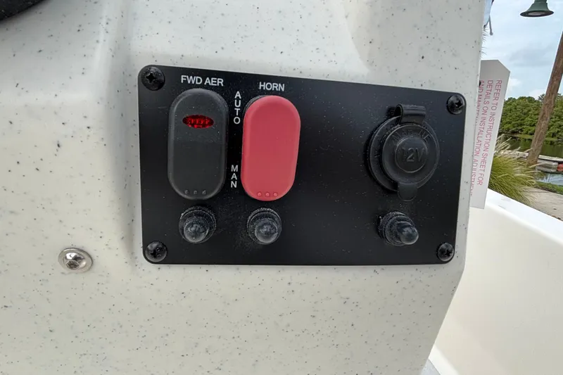 Slide: The Image of Control panel on 2026 Mako Pro Skiff 13 CC with switches and 12V outlet. - 9