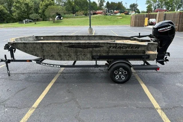 Slide: The Image of 2026 Tracker Grizzly 1650 T Prairie Wings Edition boat on trailer in parking lot. - 46
