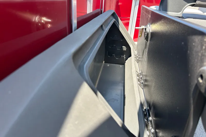 Slide: The Image of Storage compartment on 2026 Sun Tracker Fishin' Barge 22 DLX, featuring secure latch and sleek design. - 27