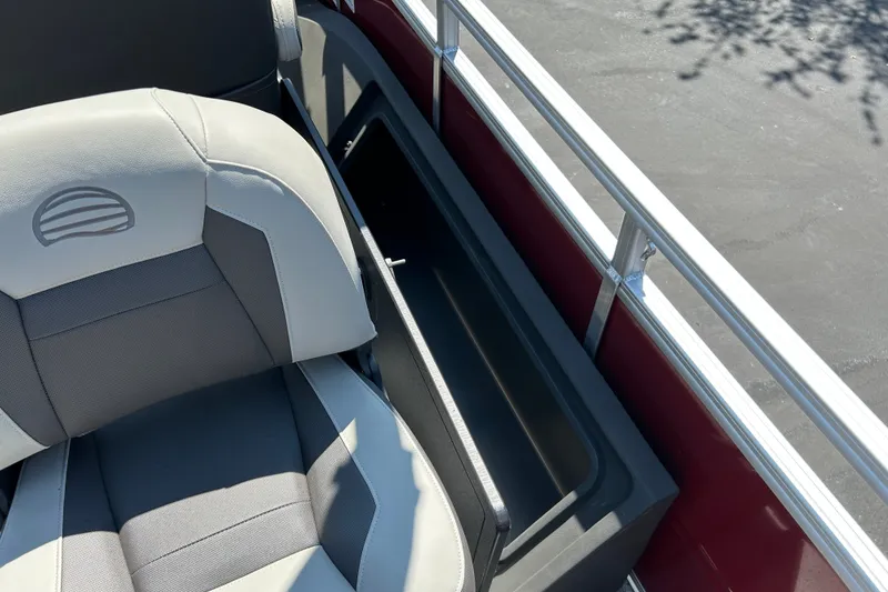 Slide: The Image of 2026 Sun Tracker Fishin' Barge 22 DLX seat and storage compartment detail. - 26