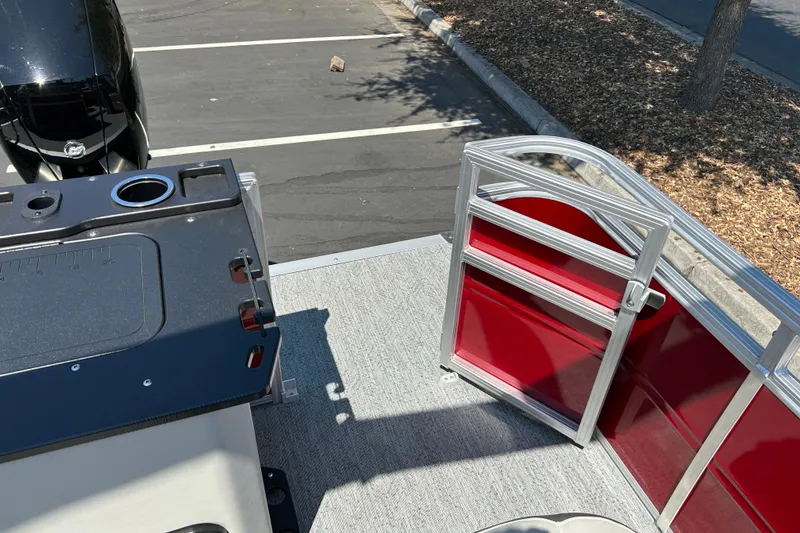 Slide: The Image of 2026 Sun Tracker Fishin' Barge 22 DLX with red paneling and fishing station. - 30