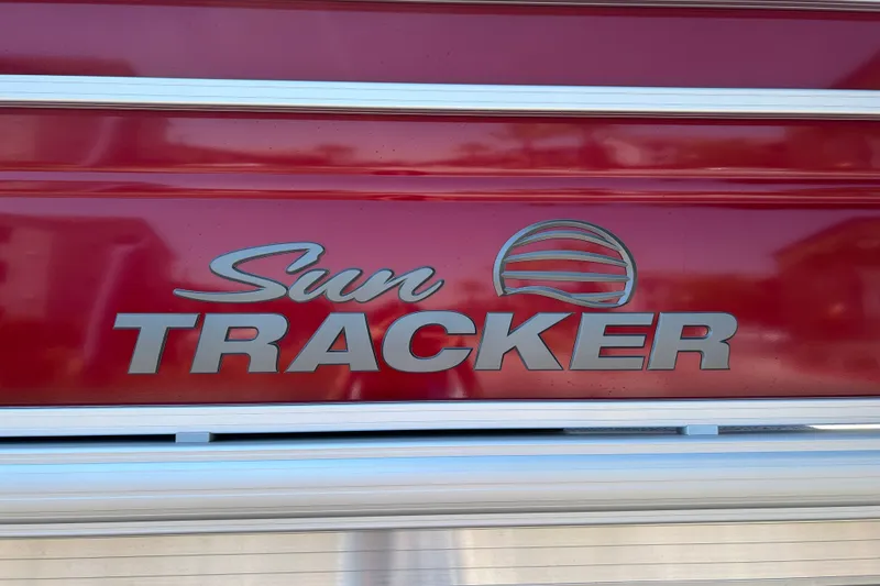 Slide: The Image of Sun Tracker Fishin' Barge 22 DLX 2026 logo on red background. - 35