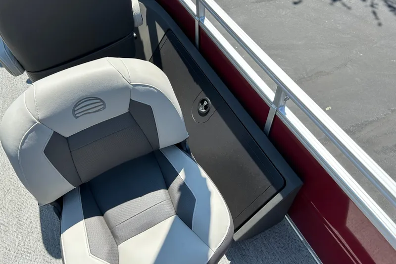 Slide: The Image of A gray and black seat on a boat with a red railing. - 25