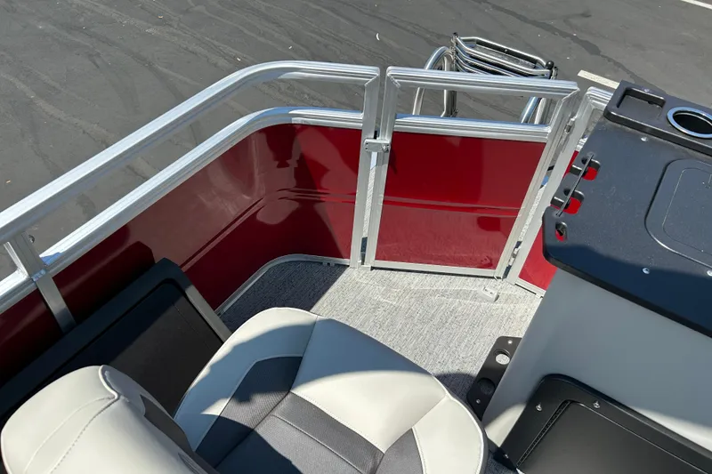 Slide: The Image of 2026 Sun Tracker Fishin' Barge 22 DLX interior with seating and railing details. - 22