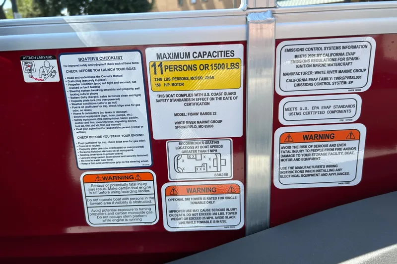 Slide: The Image of Safety and capacity labels on a 2026 Sun Tracker Fishin' Barge 22 DLX boat. - 28