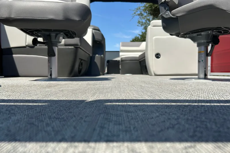 Slide: The Image of Interior view of 2026 Sun Tracker Fishin' Barge 22 DLX, showcasing seating and flooring. - 33
