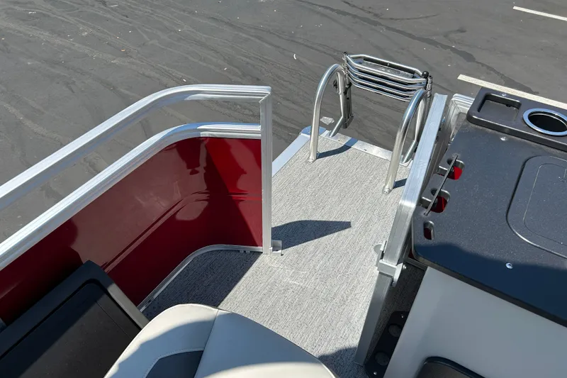 Slide: The Image of 2026 Sun Tracker Fishin' Barge 22 DLX deck with ladder and seating area. - 23