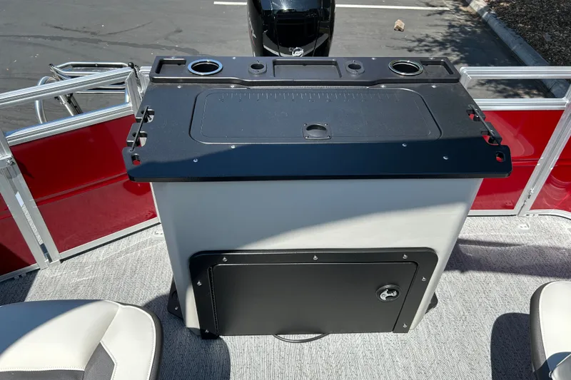 Slide: The Image of 2026 Sun Tracker Fishin' Barge 22 DLX boat interior with fishing station and seating. - 19
