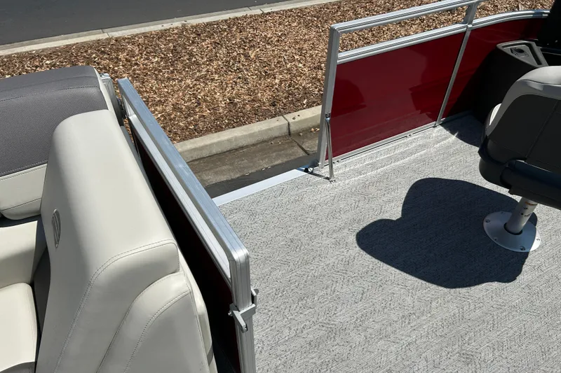 Slide: The Image of 2026 Sun Tracker Fishin' Barge 22 DLX interior with gray carpet and seating. - 32