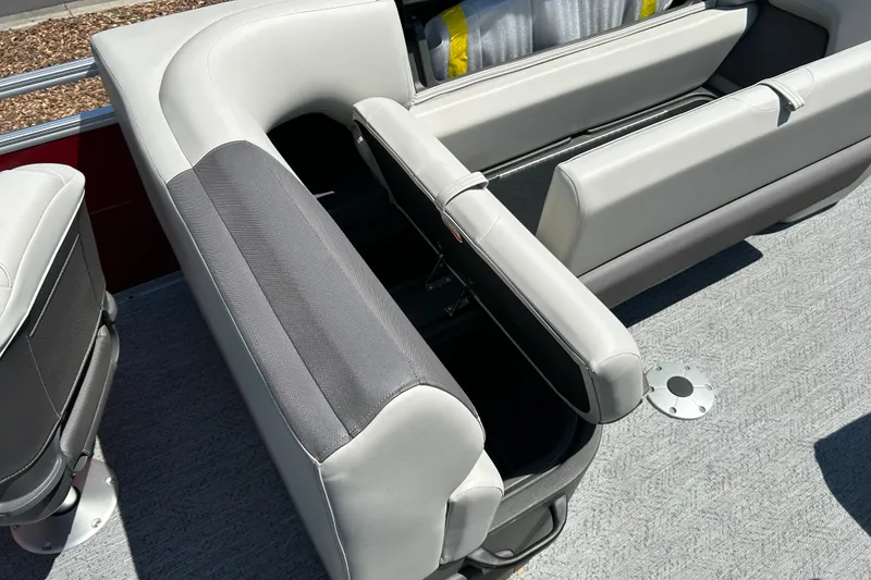 Slide: The Image of 2026 Sun Tracker Fishin' Barge 22 DLX seating with storage compartment open. - 16