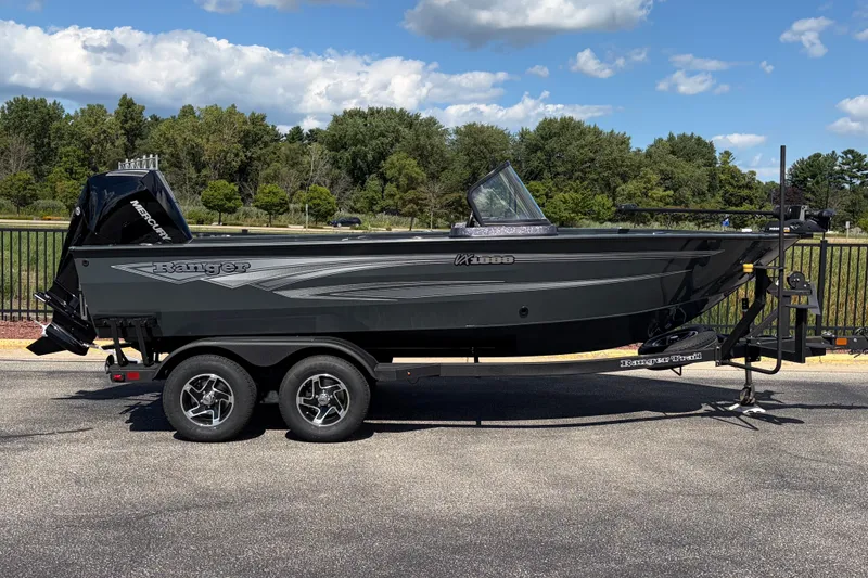 The Image of 2026 Ranger VX1888 WT fishing boat on trailer, parked outdoors under a blue sky. - 0