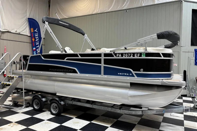 The Image of 2024 Princecraft Vectra 21 RL pontoon boat on trailer in showroom. - 1