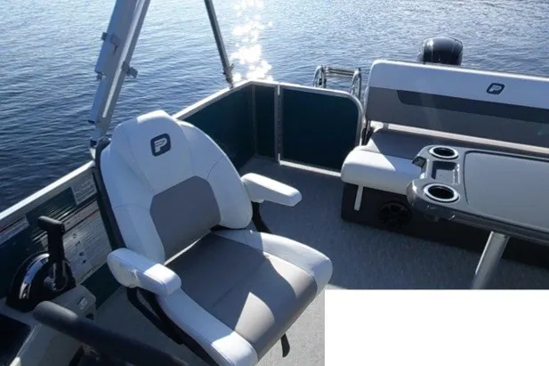 Slide: The Image of 2024 Princecraft Vectra 21 RL pontoon boat interior with seating and table on water. - 6