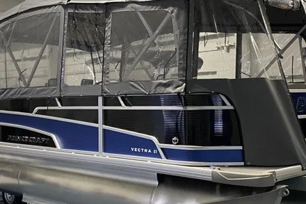 Slide: The Image of 2024 Princecraft Vectra 21 RL pontoon boat with protective canopy in a showroom. - 3