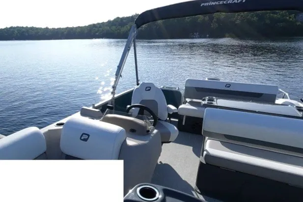 Slide: The Image of 2024 Princecraft Vectra 21 RL pontoon boat on a serene lake. - 7