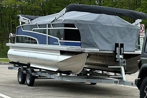 Slide: The Image of 2024 Princecraft Vectra 21 RL pontoon boat on trailer, covered and ready for transport. - 2