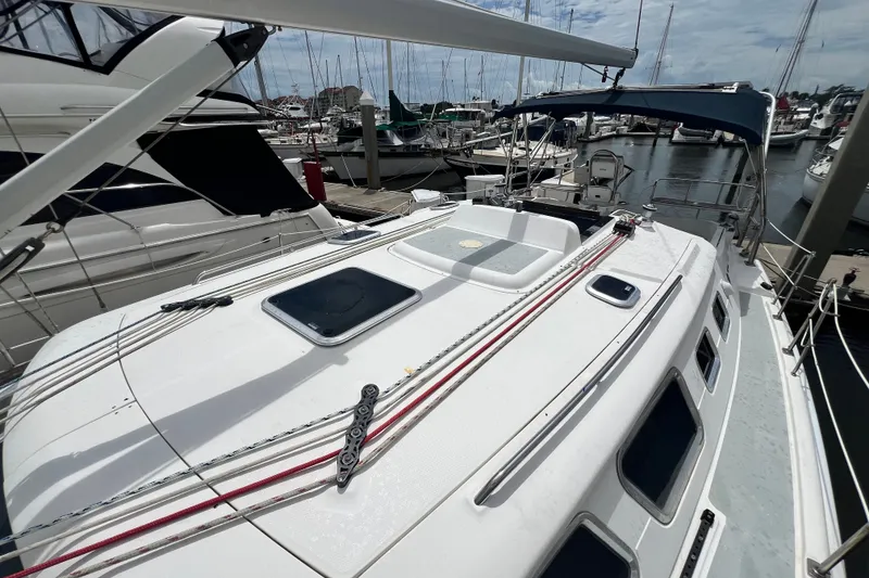 Slide: The Image of 2007 Hunter 41 Deck Salon sailboat docked at marina, showcasing deck and rigging. - 33