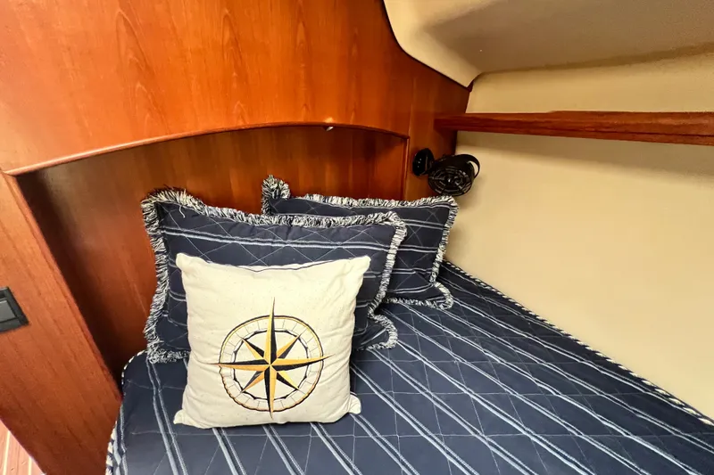 Slide: The Image of Cozy cabin interior of 2007 Hunter 41 Deck Salon with nautical-themed bedding. - 70