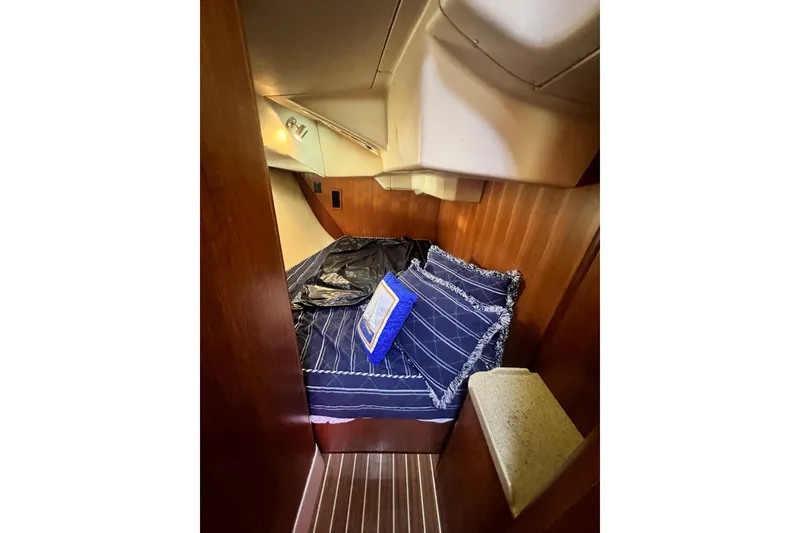 Slide: The Image of Cozy cabin interior of 2007 Hunter 41 Deck Salon with striped bedding and wooden paneling. - 85
