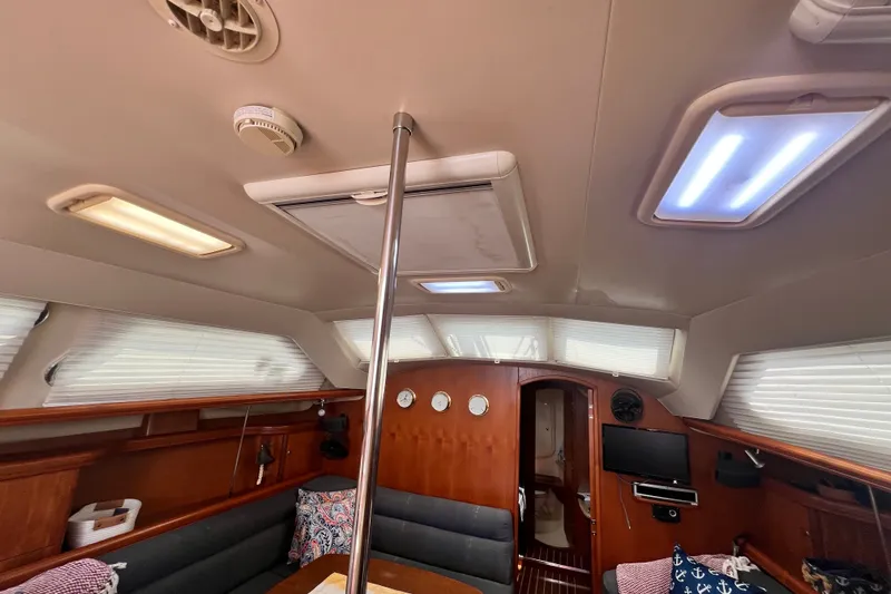 Slide: The Image of Interior of 2007 Hunter 41 Deck Salon yacht with modern amenities and cozy seating. - 57