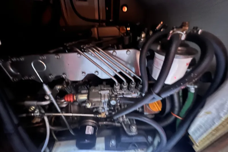 Slide: The Image of Engine compartment of a 2007 Hunter 41 Deck Salon sailboat, showcasing mechanical components. - 90