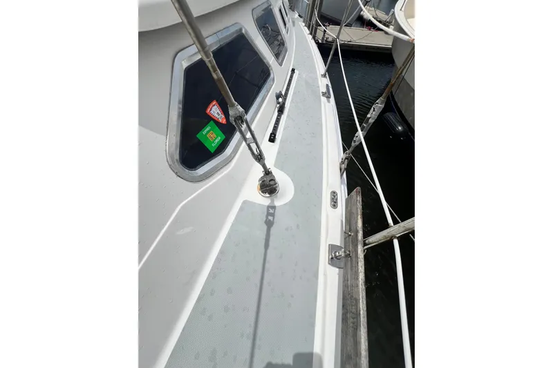 Slide: The Image of 2007 Hunter 41 Deck Salon sailboat deck with railing and windows, docked in marina. - 31