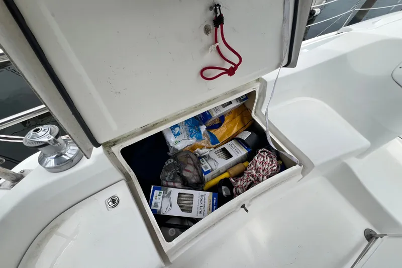 Slide: The Image of Storage compartment on a 2007 Hunter 41 Deck Salon sailboat, filled with boating supplies. - 14