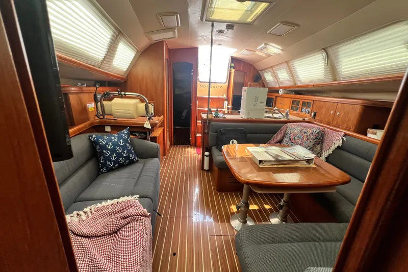 Slide: The Image of Interior of 2007 Hunter 41 Deck Salon yacht with cozy seating and wooden finishes. - 54