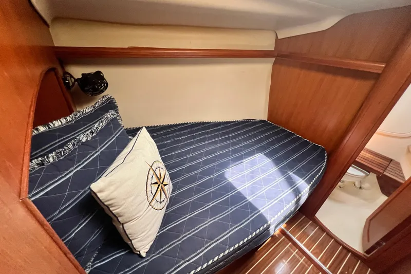 Slide: The Image of Cozy cabin interior of 2007 Hunter 41 Deck Salon with nautical-themed bedding. - 66