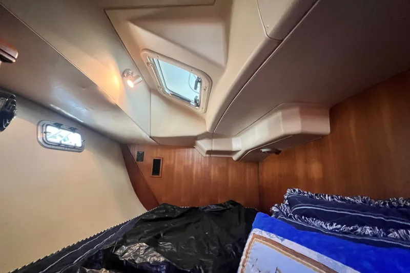 Slide: The Image of Interior cabin of 2007 Hunter 41 Deck Salon yacht with bedding and portholes. - 87