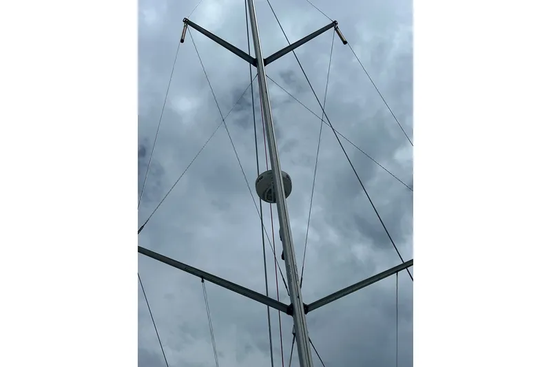 Slide: The Image of Mast and rigging of 2007 Hunter 41 Deck Salon sailboat against cloudy sky. - 28