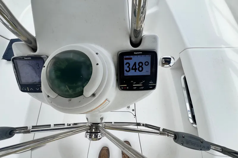 Slide: The Image of Cockpit instruments of a 2007 Hunter 41 Deck Salon sailboat, displaying a 348-degree heading. - 37