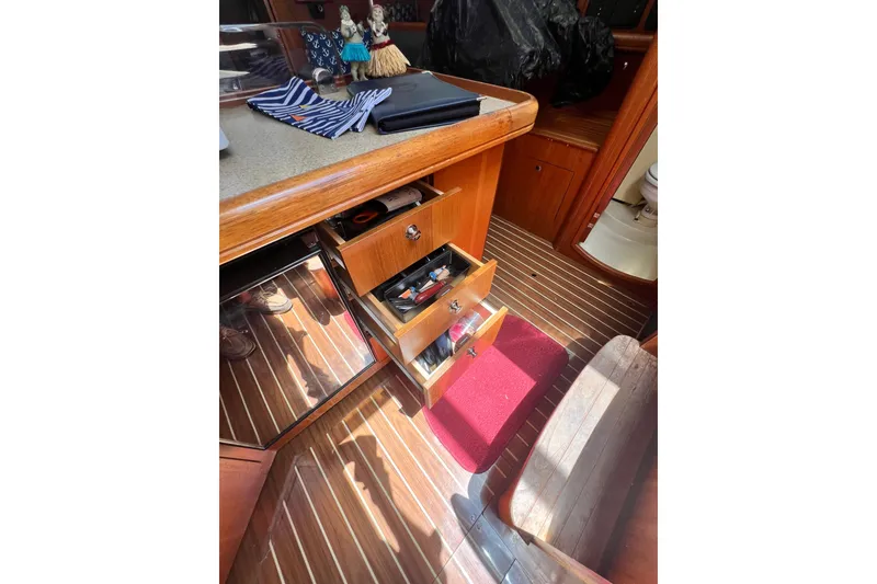 Slide: The Image of Interior of 2007 Hunter 41 Deck Salon with open drawers and nautical decor. - 64
