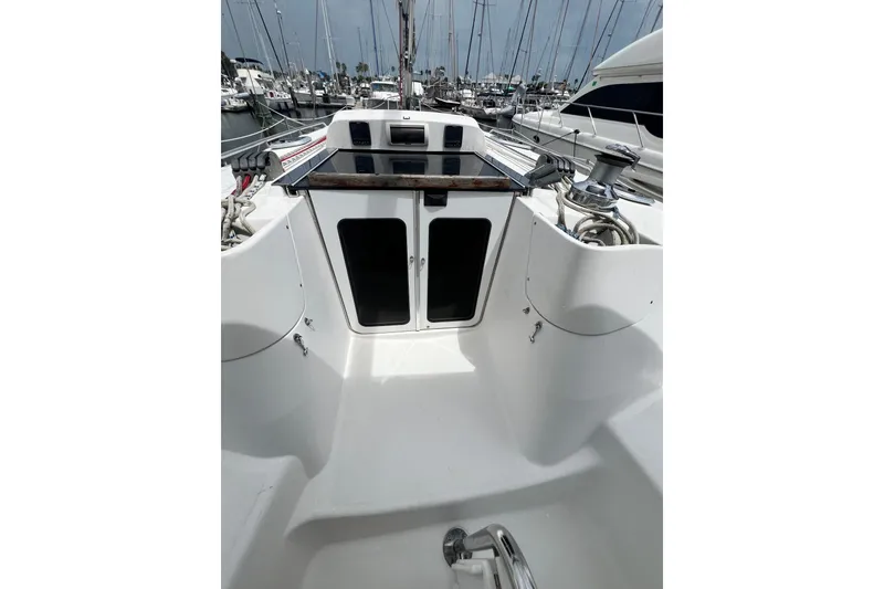 Slide: The Image of 2007 Hunter 41 Deck Salon yacht cockpit with winches and ropes in marina setting. - 47