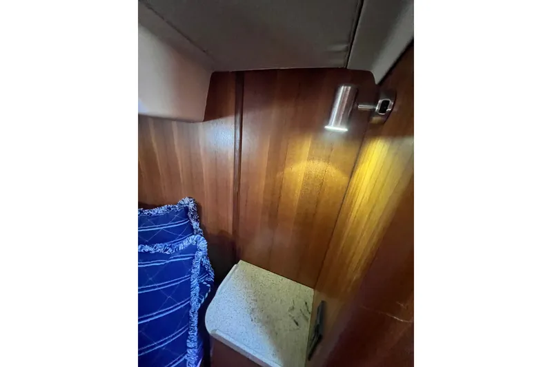 Slide: The Image of Interior of 2007 Hunter 41 Deck Salon with wood paneling and reading light. - 86