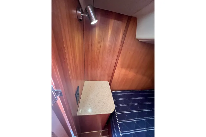 Slide: The Image of Interior of 2007 Hunter 41 Deck Salon with wooden paneling and small countertop. - 76