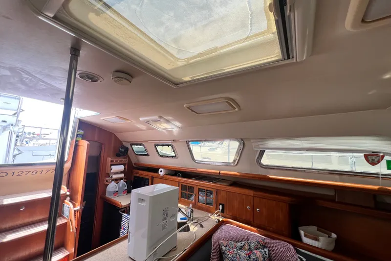 Slide: The Image of Interior of 2007 Hunter 41 Deck Salon yacht with skylight and wooden cabinetry. - 52