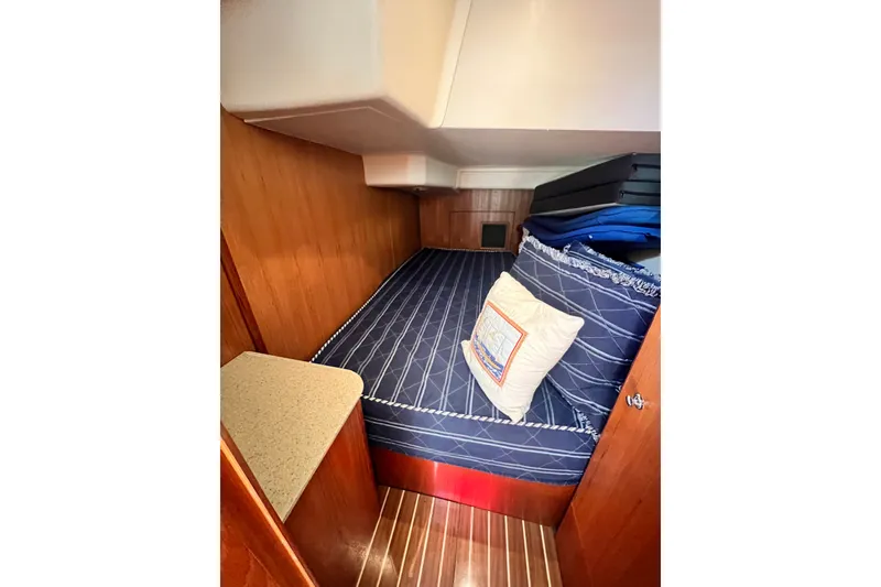 Slide: The Image of Cozy cabin interior of 2007 Hunter 41 Deck Salon with blue-striped bedding. - 75
