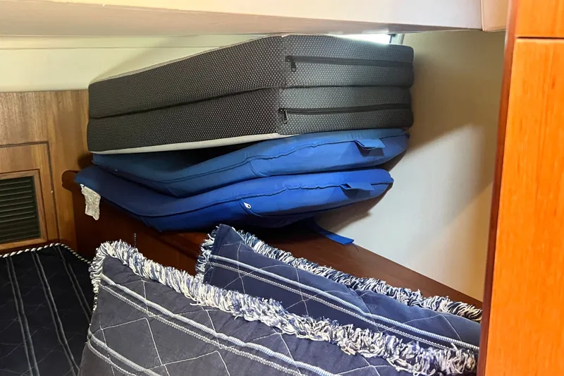 Slide: The Image of Cushions stacked in a 2007 Hunter 41 Deck Salon interior cabin. - 77