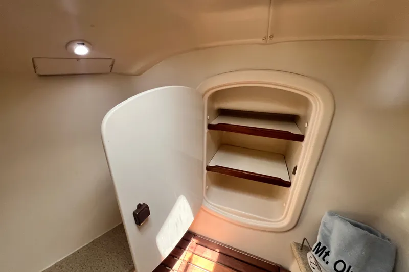 Slide: The Image of 2007 Hunter 41 Deck Salon interior cabinet with open door and wooden shelves. - 72