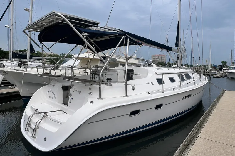 The Image of 2007 Hunter 41 Deck Salon sailboat docked at marina, featuring sleek design and spacious deck. - 0