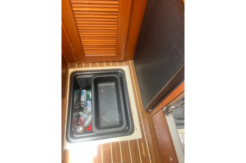 Slide: The Image of Storage compartment in 2007 Hunter 41 Deck Salon yacht interior with wooden flooring. - 65