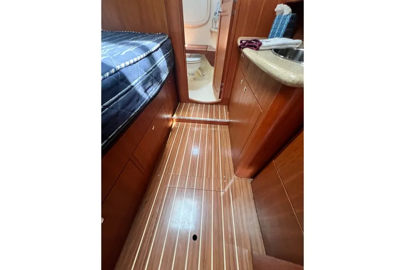 Slide: The Image of Interior of 2007 Hunter 41 Deck Salon yacht with wood flooring and compact bathroom. - 67
