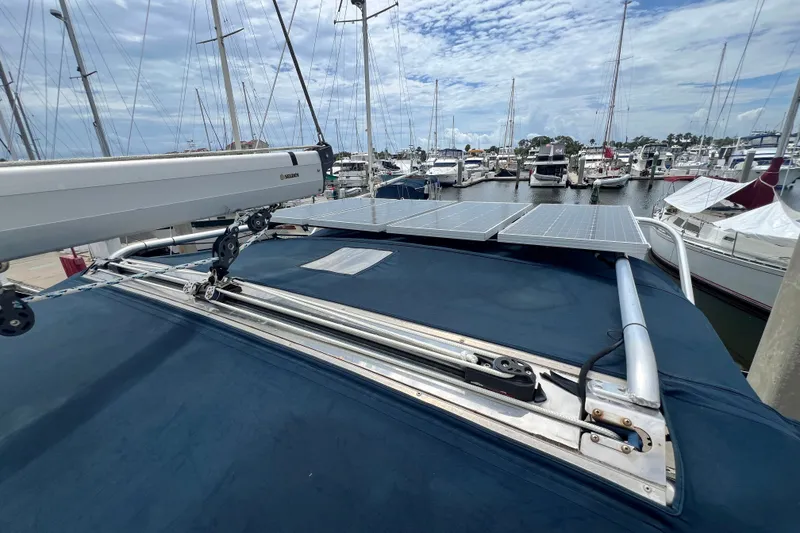 Slide: The Image of Hunter 41 Deck Salon 2007 with solar panels at marina, under a partly cloudy sky. - 35