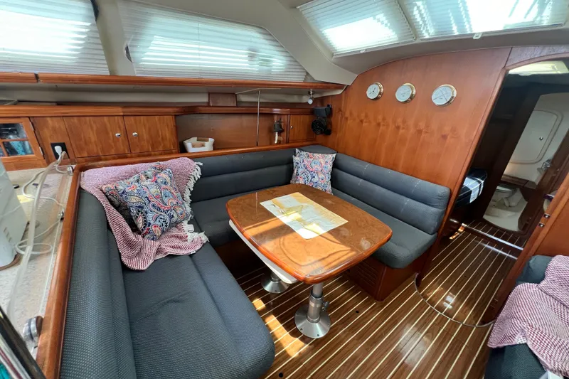 Slide: The Image of Interior of 2007 Hunter 41 Deck Salon with cozy seating and wooden finishes. - 56