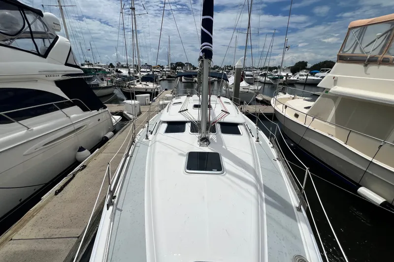 Slide: The Image of 2007 Hunter 41 Deck Salon yacht docked at a marina, surrounded by other boats. - 24