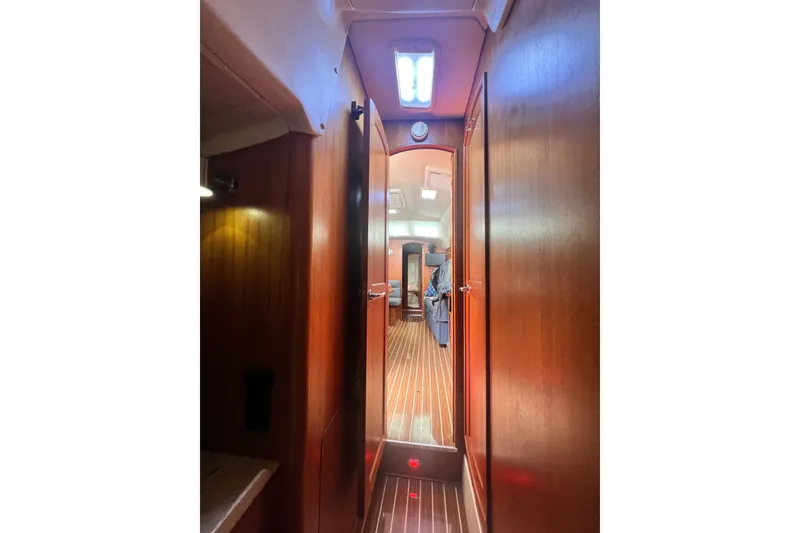 Slide: The Image of Interior view of 2007 Hunter 41 Deck Salon with wooden finishes and bright lighting. - 84