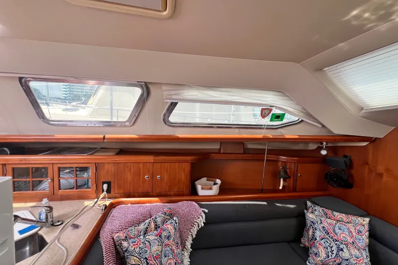 Slide: The Image of Interior of 2007 Hunter 41 Deck Salon with cozy seating and wooden cabinetry. - 51